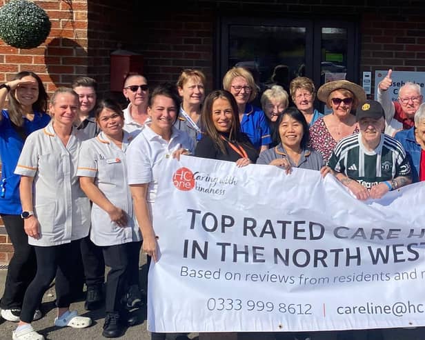 Rosebridge Court colleagues and residents holding up their Top 20 Carehome.co.uk awards banner