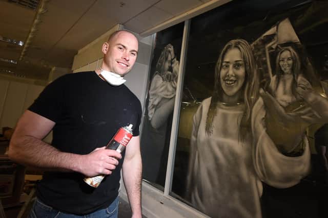 Scott Wilcock of Snow Graffiti, working on a mural for mental health in an empty unit in The Galleries