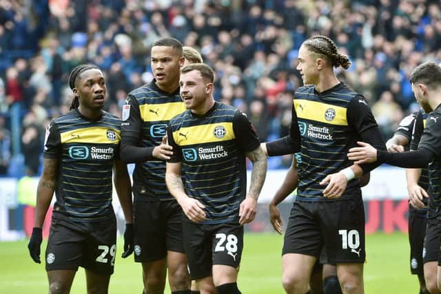 Dale Taylor is mobbed after giving Latics the lead at Bolton