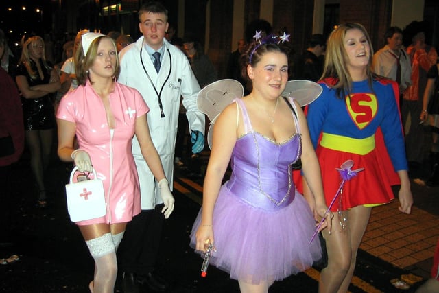 Fancy dress characters arrive on  Wigan's King Street during Boxing Day night's fancy dress tradition in 2003.