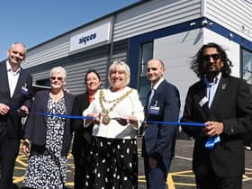 The Mayor of Wigan Coun Marie Morgan, centre, cuts the ribbon to officially open Algeco, Europe's leading modular and offsite building solutions brand, on the former site of Morrisons supermarket, Ince, Wigan.