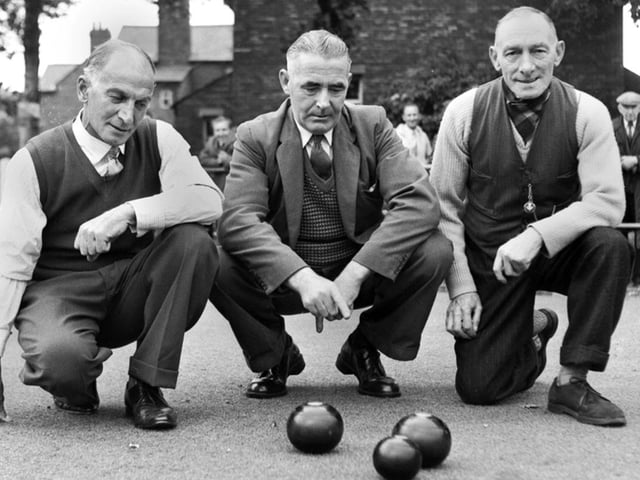 Some gentleman bowlers study the woods on a Wigan green in the 1960s.