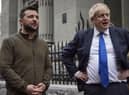 In this image provided by the Ukrainian Presidential Press Office, Ukrainian President Volodymyr Zelenskyy, left, and Britain's Prime Minister Boris Johnson talk during their walk in downtown Kyiv, Ukraine