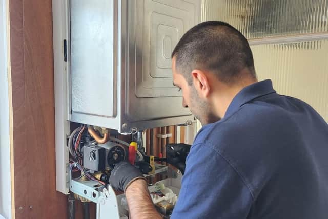 A heating engineer working on a boiler
