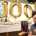 Jim Winstanley celebrates his 100th birthday, pictured with a telegram card from King Charles and Queen Consort, at Alma Green Care Home, Upholland.