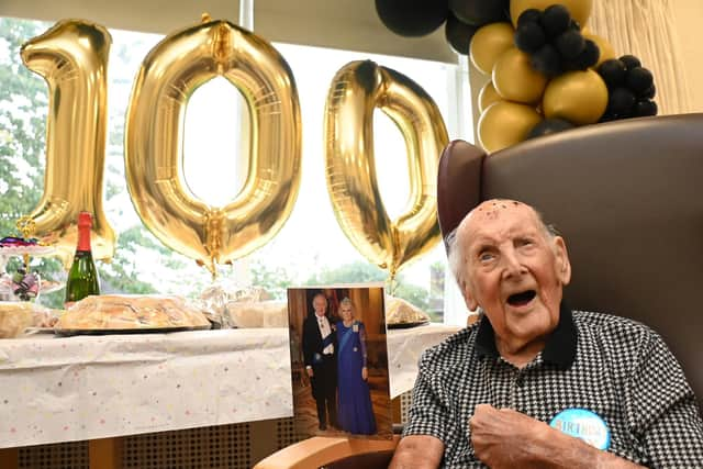 Jim Winstanley celebrates his 100th birthday, pictured with a telegram card from King Charles and Queen Consort, at Alma Green Care Home, Upholland.