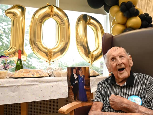 Jim Winstanley celebrates his 100th birthday, pictured with a telegram card from King Charles and Queen Consort, at Alma Green Care Home, Upholland.