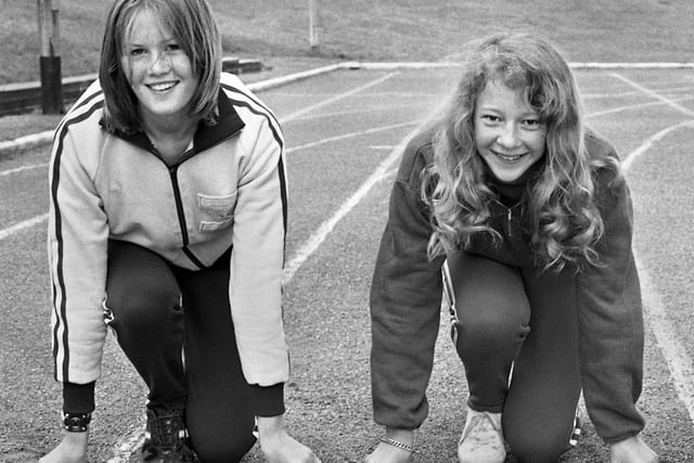 Wigan girls Kathleen Griffin, left, who was competing in the Junior 800 metres and Morag Rogers in the Junior 100 metres at the Lancashire Schools Athletics Championships held at Woodhouse Stadium on June 8, 1974.