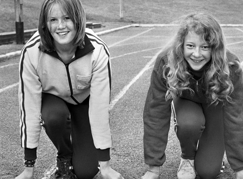Wigan girls Kathleen Griffin, left, who was competing in the Junior 800 metres and Morag Rogers in the Junior 100 metres at the Lancashire Schools Athletics Championships held at Woodhouse Stadium on June 8, 1974.