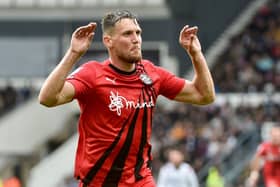 Charlie Wyke in familiar pose after scoring for Latics at Derby last term