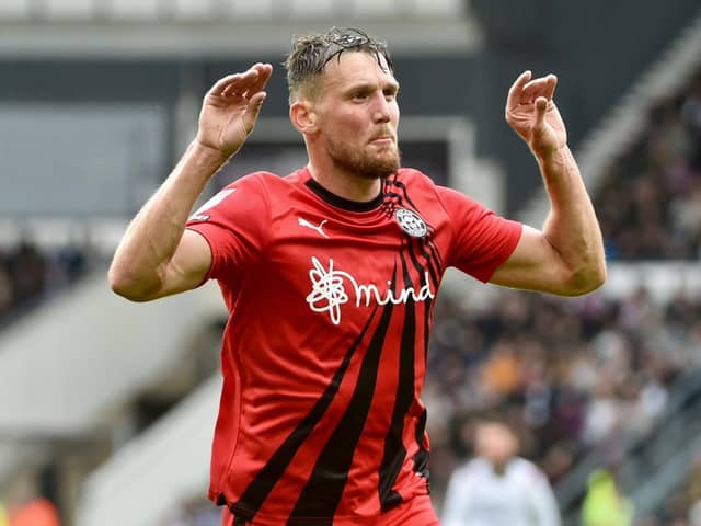 Charlie Wyke in familiar pose after scoring for Latics at Derby last term