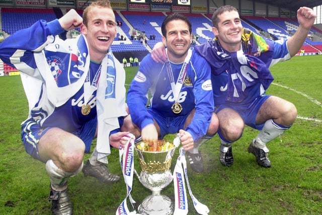 Celebrations from Neil Roberts, Andy Liddell and Lee McCulloch as Wigan Athletic lift the Division 2 championship trophy after beating Barnsley 1-0 with a Tony Dinning goal  on Saturday 3rd of May, the last day of the 2002/2003 season.  