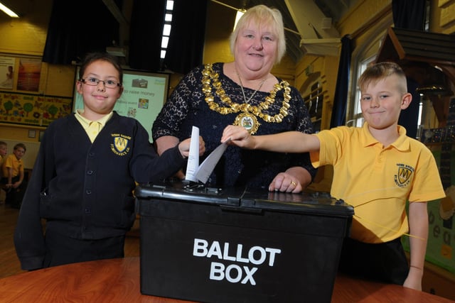Pupils take part in a vote to decide how to raise funds for the school, as Mayor of Wigan Coun Susan Loudon, centre, visited year four pupils to talk about her role during Local Democracy Week