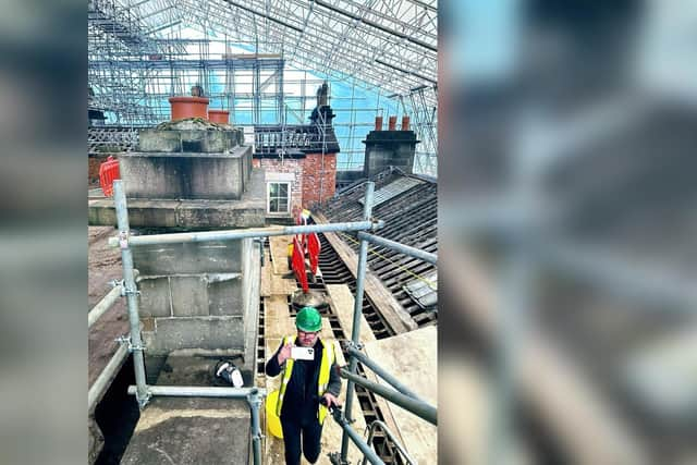 Under the protective covers over Haigh Hall's roof