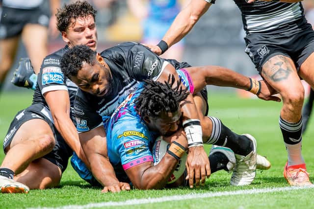 Picture by Allan McKenzie/SWpix.com - 20/07/2024 - Rugby League - Betfred Super League Round 18 - Hull FC v Wigan Warriors - MKM Stadium, Kingston upon Hull, England - Wigan's Junior Nsemba is held up on the goal line by Hull FC's King Vuniyayawa. : Junior