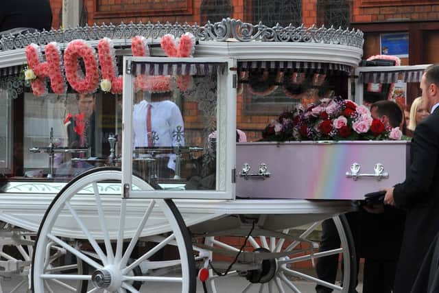 The pink coffin was carried into the church