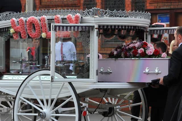 The pink coffin was carried into the church