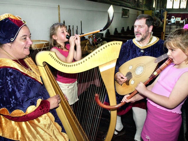 Tuning in to Medieval times are Lauren and Sophie Stewart with Glynis and Brian Radford of Tapestry of Music at the Medieval Fair at St. Thomas the Martyr Church, Upholland, on Saturday 13th of July 2002.