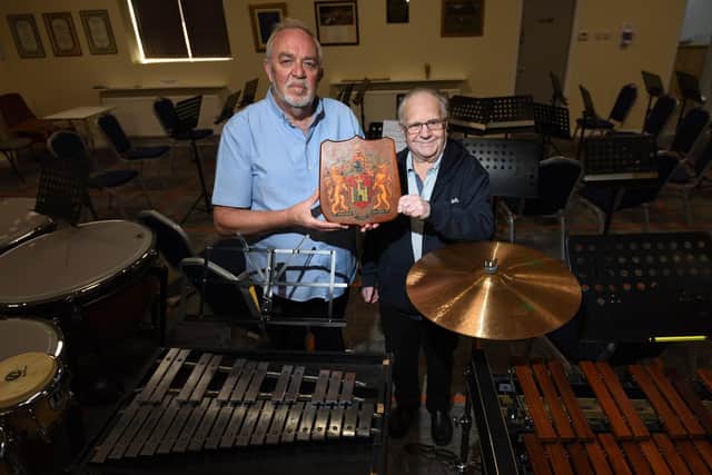 George Fairhurst and Derek Green, right, at Pemberton Old Wigan Brass Band, with the Wigan Coat of Arms. Made in 1922, it was sent to the group by Wiganer, Derek Winstanley, who now lives in America.