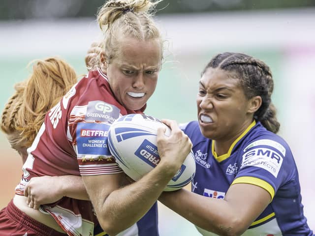 Wigan's Anna Davies is tackled by Leeds's Sophie Robinson