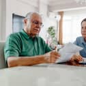 Mature couple looking at bill