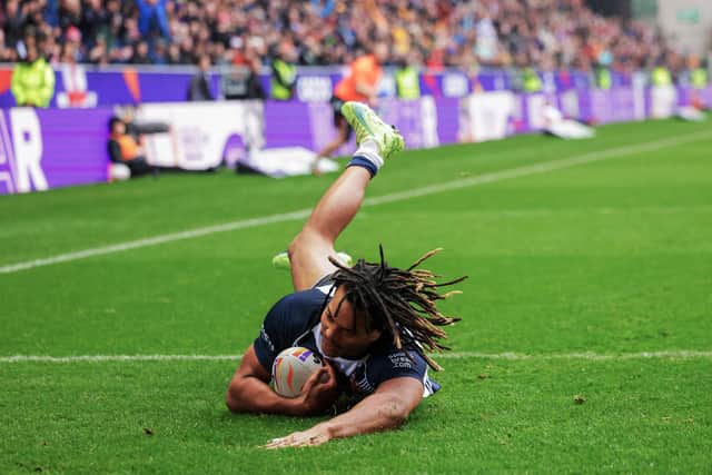 England’s Dom Young scores a try against PNG at the DW Stadium in the World Cup quarter-finals