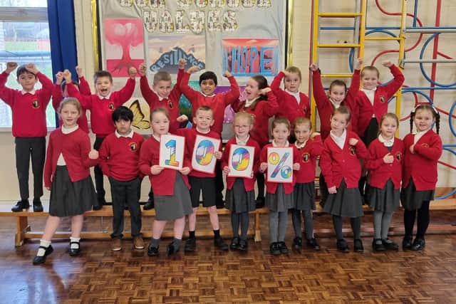 Pupils at Billinge Chapel End Primary School celebrate after learning it is in the top one per cent of primary schools in England for phonics and early reading