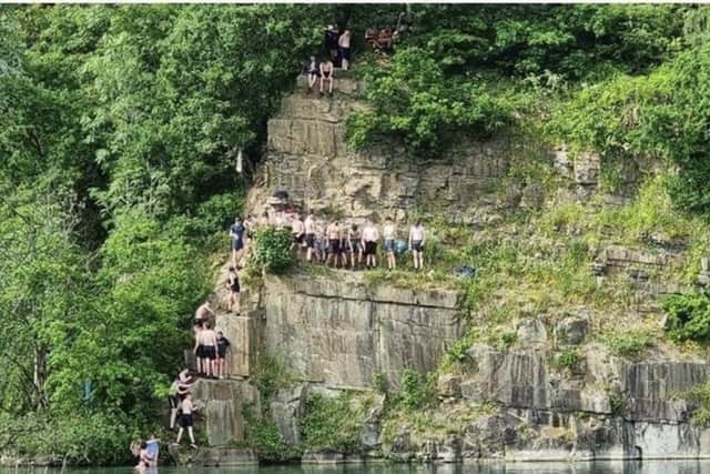 An old picture of teenagers jumping into the quarry at Appley Bridge