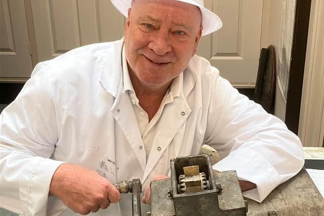 Antony Winnard demonstrates what is thought to be the world's oldest humbug machine, which is going on display at the Museum of Wigan Life