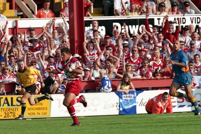 Wigan fans erupt as winger Jason Robinson scorches in for one of his two tries against St. Helens.