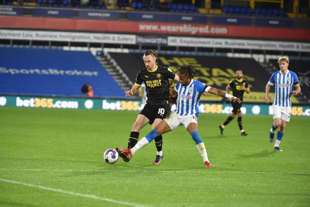 Will Keane in action for Latics at Huddersfield