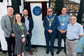 The blue plaque is unveiled at Real Crafty on Upper Dicconson Street