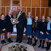 Mayor of Wigan Coun Kevin Anderson presents the trophy to pupils from St Wilfrid's C of E Primary Academy, Standish, with runners-up from St Mary and St John's RC Primary School, right