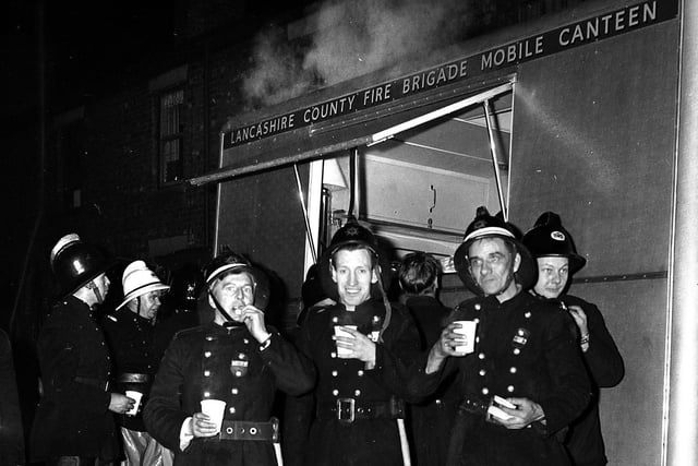 RETRO 1967 Firefighters take a break as they tackle the blaze at Taylor's Mill.  Wigan saw its share of serious fires in former textile mills, including Victoria Mills (Taylor’s Carpets) in January 1967.