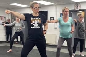 Parents learn new moves during the karate class