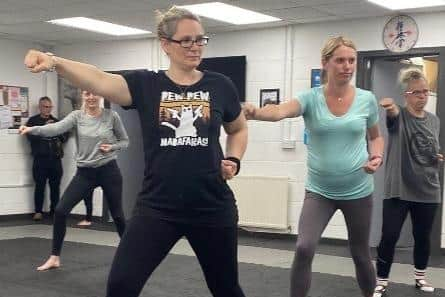 Parents learn new moves during the karate class