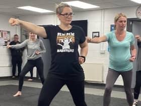 Parents learn new moves during the karate class