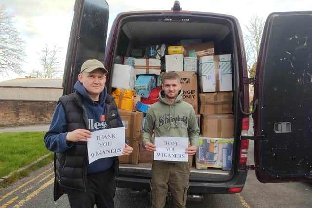 Volunteers with a van of donations