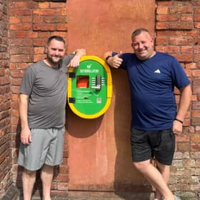 Tom and Ian with the defibrillator that saved Ian's life