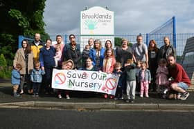 Parents, children and members of the community outside Brooklands Childcare, Garswood, which has announced it will close in a few weeks