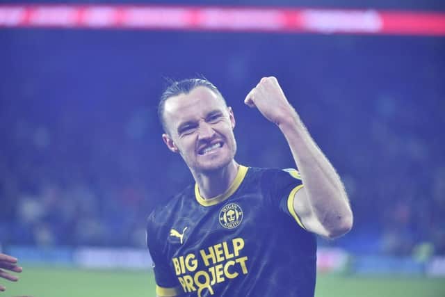 Will Keane celebrates his last-gasp leveller at Cardiff in front of the away end