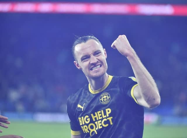 Will Keane celebrates his last-gasp leveller at Cardiff in front of the away end