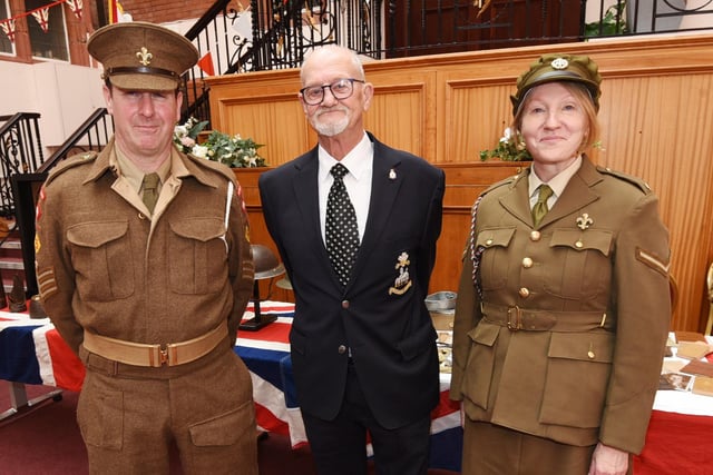 Dave Myers, left, and Deborah Pugh, right, from 5th Bn. Manchester Regiment Living History Museum, meet veteran John Heaton.