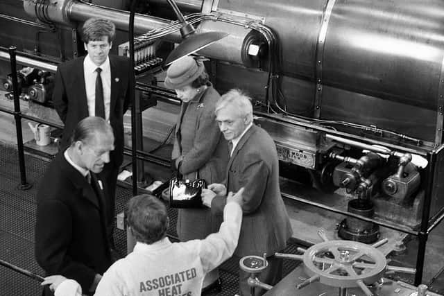 The Duke of Edinburgh hears all the secrets of Trencherfield Mill's engine from engineer Ted Melling as the Queen peers at something else of interest. Looking on are council leader Bernard Coyle and assistant planning officer Alan Wenham, on the occasion of the Queen opening Wigan Pier on March 21, 1986.