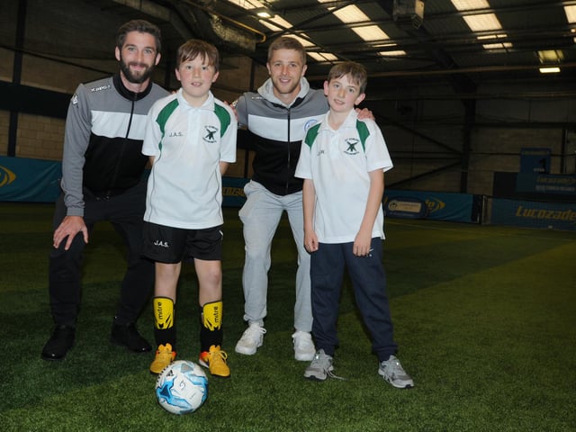Action from a disability football tournament, where teams from schools in the area played for a trophy, at the Lucozade Powerleague Soccerdome, Wigan. Wigan Athletic players Will Grigg, left, and Michael Jacobs, second from right, joined in