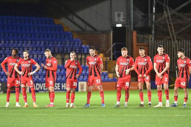 The Latics players ready themselves for the penalty shoot-out at Tranmere