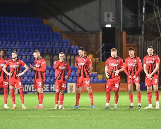 The Latics players ready themselves for the penalty shoot-out at Tranmere