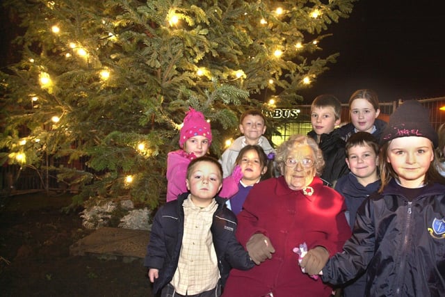 101 Year old Cissie Garston with local youngsters after she had switched on the Bryn Christmas tree lights. Picture Frank Orrell. Request Richard