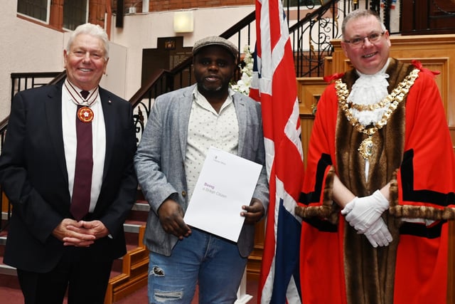 Greater Manchester Deputy Lieutenant Martin Ainscough, left,  and Mayor of Wigan Coun Kevin Anderson, right, welcomes Wigan's new British Citizens as certificates were presented at the monthly British Citizenship ceremony held at Wigan Town Hall.