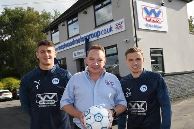 Westwood Motor Group managing director Chris Melling, centre, with Latics players Sam Tickle, left, and Scott Smith, right.